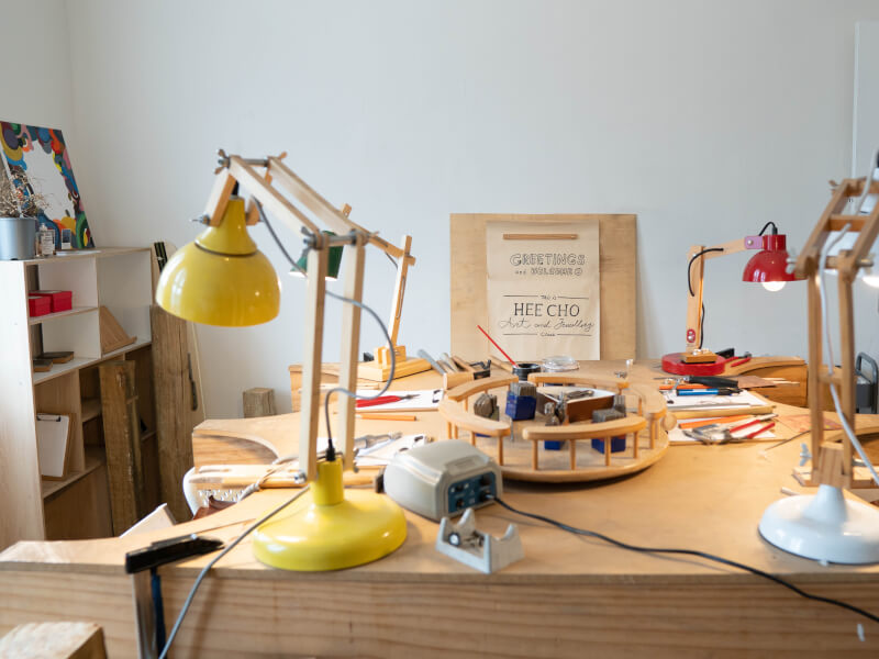 An arrangement of jewellery making tools on a workshop bench